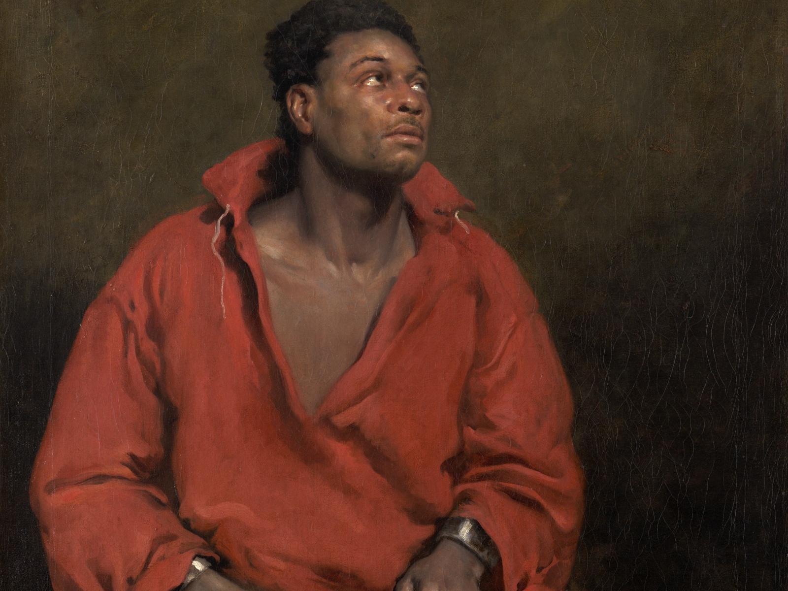 The actor Ira Aldridge sits in chains and looks upward in John Philip Simpson's painting The Captive Slave.