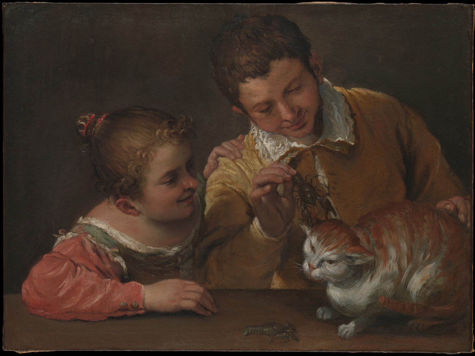Two children grin while holding crayfish pincers close to a wary cat in Annibale Carracci's painting.