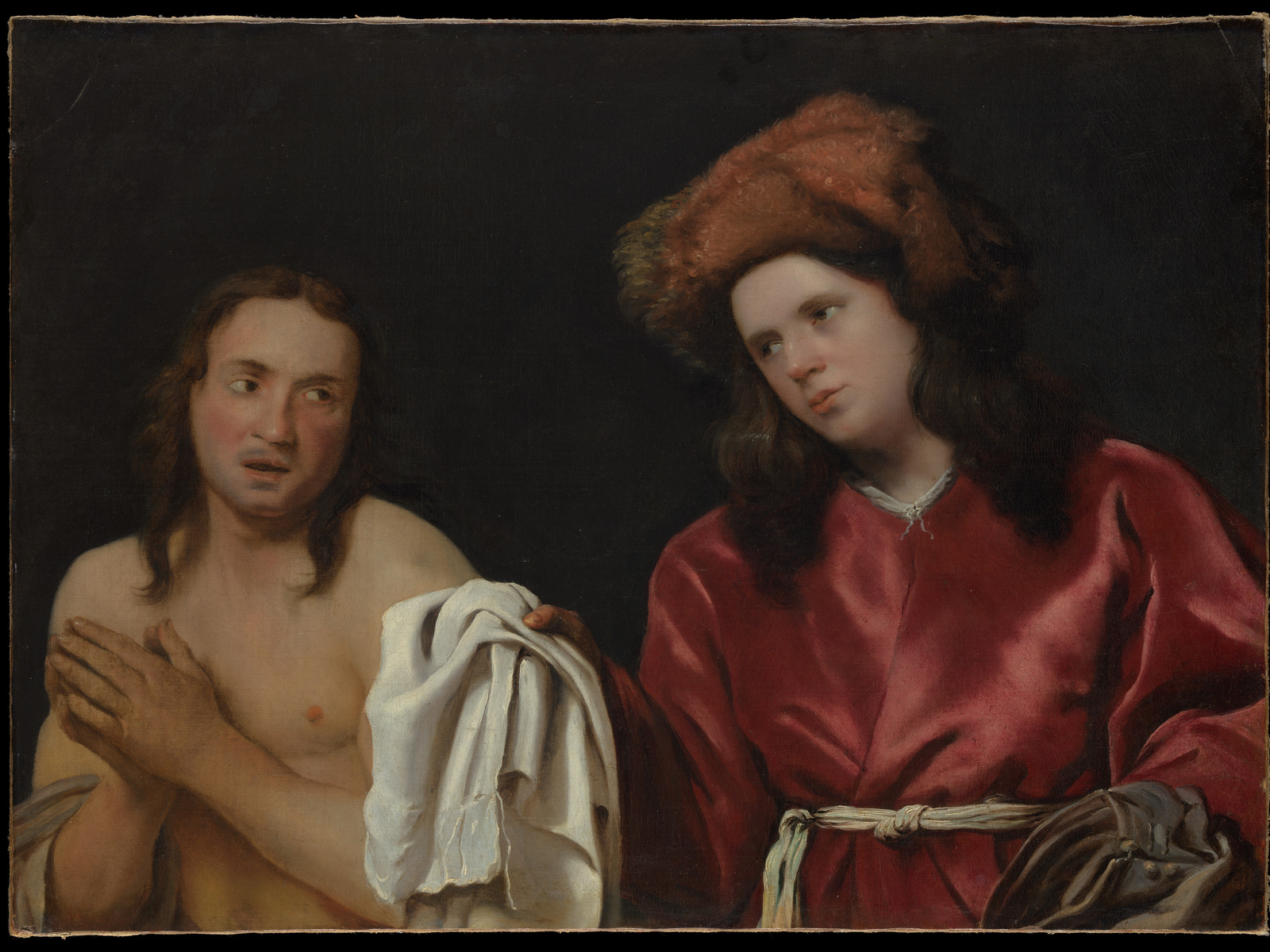 Two men face one another as one offers a white garment; both complete heads and hair silhouettes are visible.