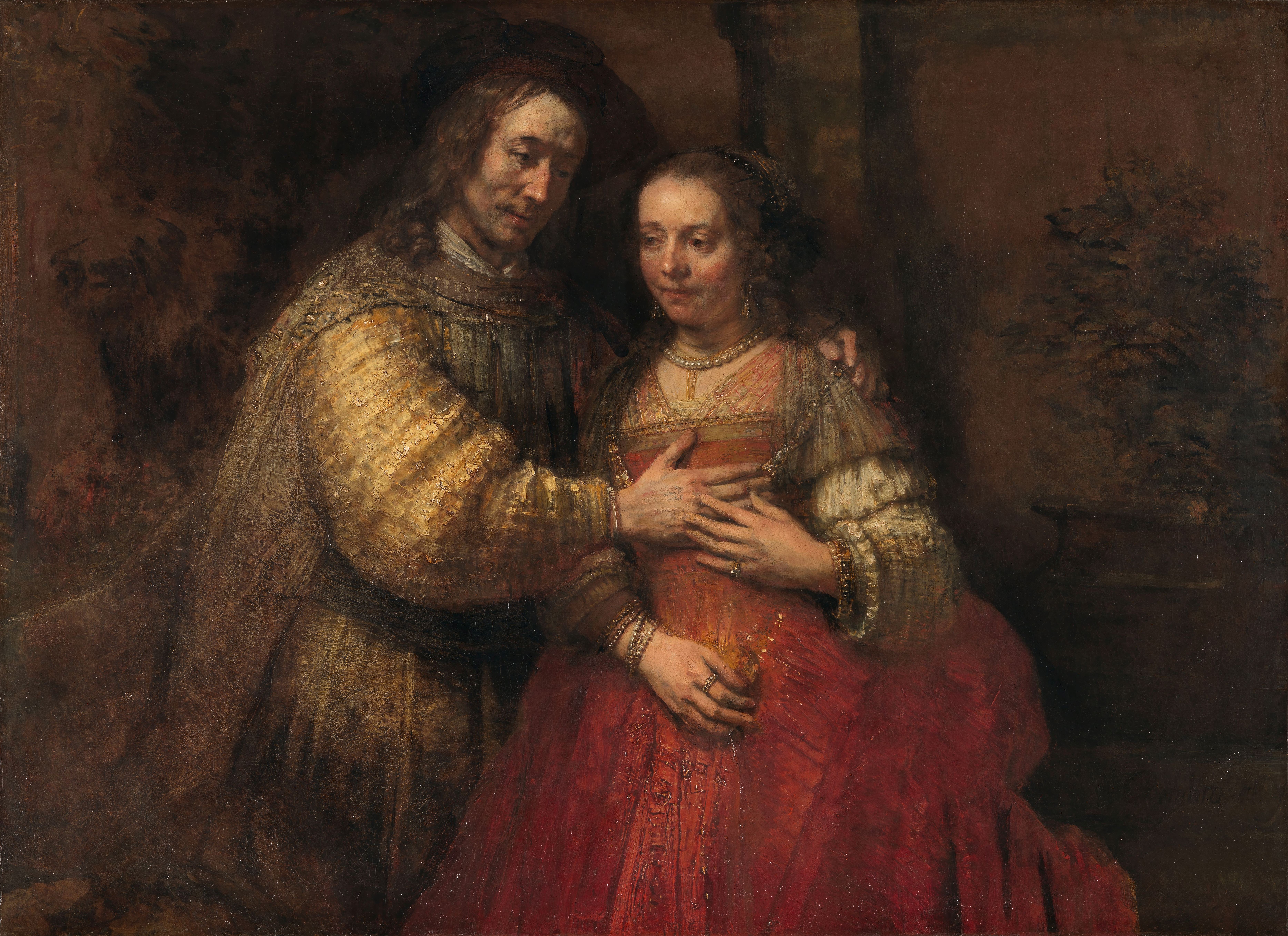 Isaac and Rebecca stand closely together, their faces and overlapping hands emerging from a dark painted background.